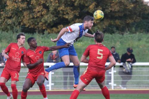 IMG 6940-Enfields-Adam-Cunnington-wins-a-header-against-Rudy-Allen-as-Alex-Fisher-L-and-Bernard-Tanner-R-look-on