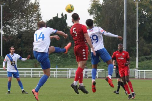 IMG 6233-Worthings-Aarran-Racine-heads-clear-from-Adam-Cunnington-14-and-Manny-Maja