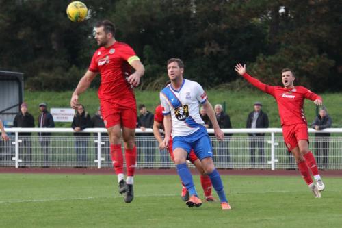 IMG 6267-Worthings-Aarran-Racine-heads-clear-from-Adam-Cunnington-as-Joel-Colbran-appeals-presumably-for-an-offside