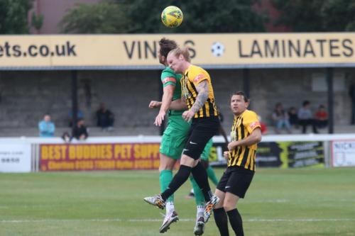 Enfield's Adam Cunnington (green) challenges Finn O'Mara