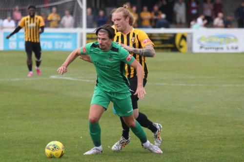 Folkestone's Finn O'Mara (R) challenges Sam Youngs