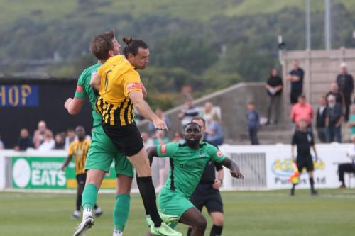 Folkestone's Ryan Johnson (6 challenges Adam Cunnington