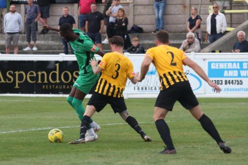 Enfield's Muhammadu Faal and Folkestone's Jordan Wright (3) and Josh Vincent