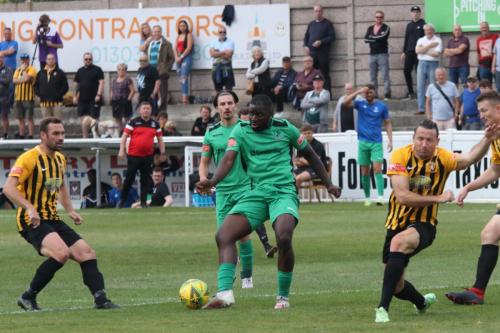 Enfield's Percy Kiangebeni (green) tries to collect the rebound after Ryan Johnson's (R) block