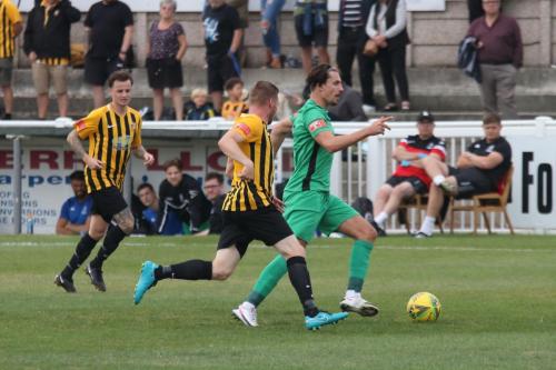 Enfield's Sam Youngs (R) chased by Scott Heard