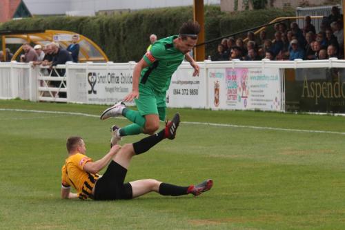 Folkestone's Callum Davies tackles Sam Youngs