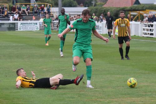 Folkestone's Callum Davies tackles Adam Cunnington