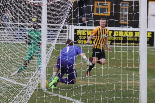 Folkestone keeper Tim Roberts is alert as Muhammadu Faal tries to squeeze a shot in at the near post