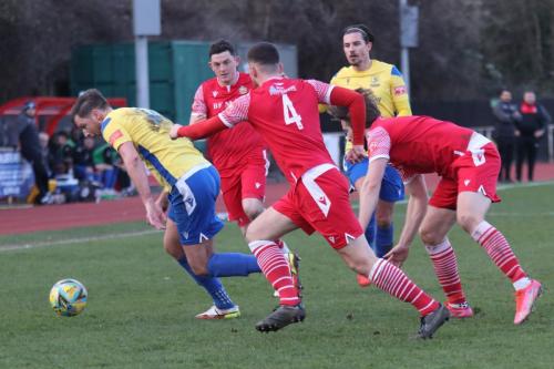 IMG 4046-Adam-Cunnington-tries-to-get-clear-from-Jordan-Clark-4-and-Remi-Sutton