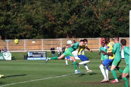 IMG 5554-A-ball-into-the-Leatherhead-box-is-half-cleared-but-only-as-far-as-Percy-Kiangebeni-who-scores-the-second-goal