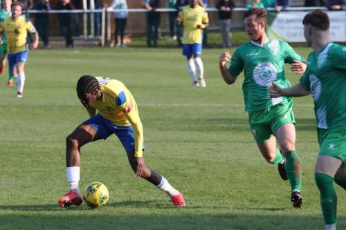IMG 5592-Enfields-Andre-Coker-tries-to-regain-his-footing-after-being-clipped-by-Leatherheads-Craig-McGee