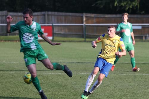 IMG 5667-Enfields-Ryan-Kirwan-R-sees-his-cross-blocked-by-Craig-McGee