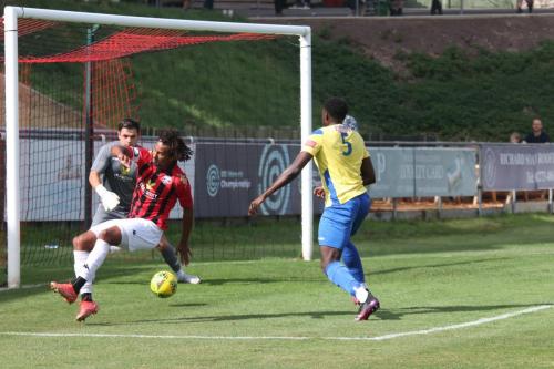 IMG 4160-Enfields-Jerry-Gyebi-yellow-bundles-the-ball-past-Mitchell-Nelson-but-without-the-pace-to-trouble-keeper-Lewis-Carey