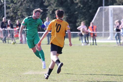 IMG 4931-Scott-Thomas-L-heads-the-ball-past-Finlay-Lovatt-and-back-into-the-penalty-area