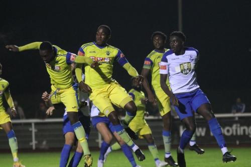 IMG 4340-Enfields-Jerry-Gyebi-R-is-beaten-to-the-ball-by-the-Haringey-defence