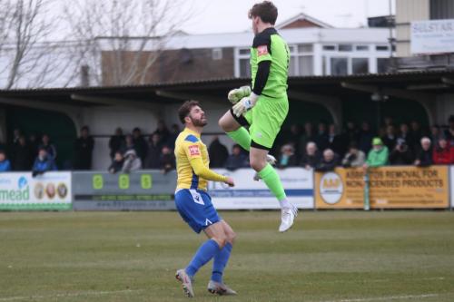 IMG 5699-Bognor-keeper-Matt-Rowley-heads-clear-from-Jake-Cass
