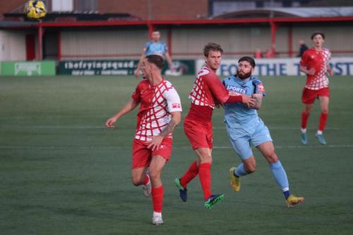 IMG 1007-There-appears-to-be-little-danger-as-Ollie-Cook-centre-holds-off-Jake-Cass-but-Bradley-Williams-unaccountably-heads-past-his-own-keeper-for-the-third-Enfield-goal
