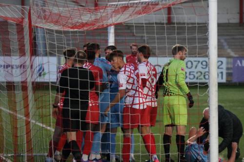 IMG 1032-While-Sam-Youngs-receives-treatment-for-the-injury-that-ended-his-game-the-teams-discuss-its-cause.