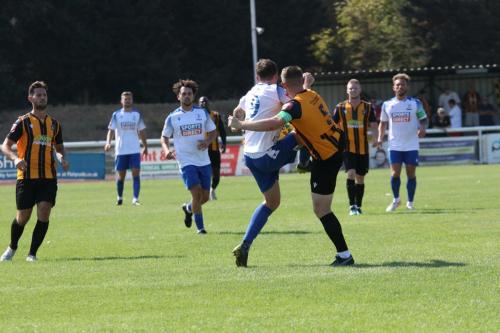 IMG 6655-Folkestone-captain-Callum-Davies-clears-from-Jake-Cass