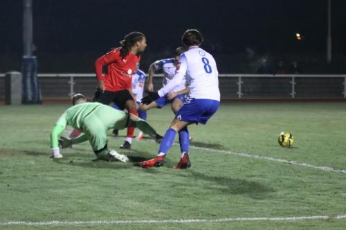 IMG 3305-Billericay-keeper-Harry-Seaden-and-captain-Michael-Chambers-scramble-the-ball-clear-from-Sam-Youngs-8-and-Adam-Cunnington