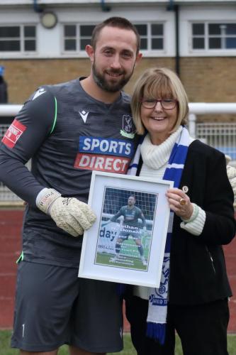 IMG 3439-Enfield-goalkeeper-Nathar-McDonald-receives-a-memento-from-club-director-Christine-Hamilton-to-mark-his-300th-appearance