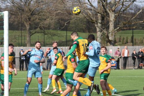 IMG 8461-Horshams-Shamir-Fenelon-heads-the-ball-out-under-pressure-from-Michael-Bakare