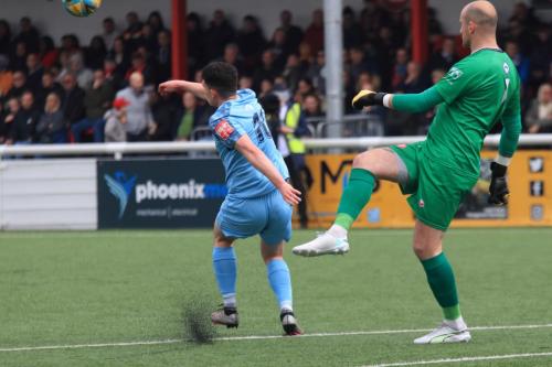 IMG 3025-Marcus-Wyllie-almost-blocks-a-clearance-from-Mitchell-Beeney.-I-think-the-ball-clipped-his-left-heel