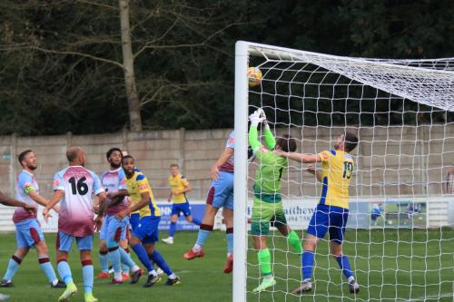 IMG 2276-Chesham-keeper-Zaki-Oualah-is-blocked-by-team-mate-Eoin-Casey-preventing-a-clean-punch