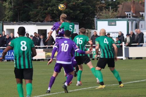 IMG 2460-Enfields-James-Richmond-wins-a-header-against-Kiki-Oshijala