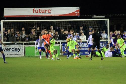 IMG 2856-Enfield-scramble-the-ball-clear-in-the-dying-moments.-The-orange-jersey-in-the-centre-of-the-frame-belongs-to-Wingate-keeper-Ben-Goode