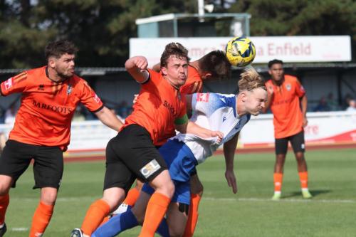 IMG 1089-Enfields-James-Richmond-challenges-at-a-long-throw-marked-by-Calvin-Davies-front-and-Craig-Robson