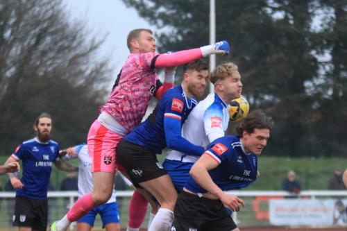 IMG 5387-Margate-keeper-Harry-Seaden-just-about-manages-to-punch-clear-from-Lewis-Knight-James-Richmond-and-Harry-Hudson