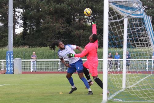 IMG 0010-Lamar-Johnson-palms-the-ball-away-from-Joshua-Okotcha