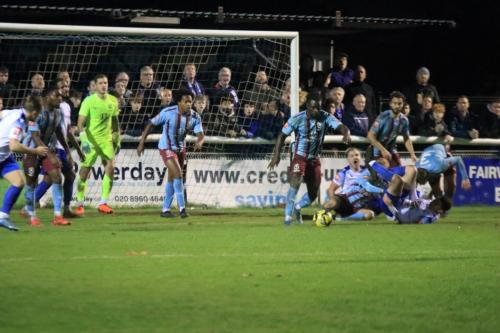IMG 4390-Hastings-Jason-Fregne-tidies-up-after-a-scramble-in-the-penalty-area-Enfields-Lewis-Taaffe-cant-make-contact-as-the-ball-passes-through-the-penalty-area