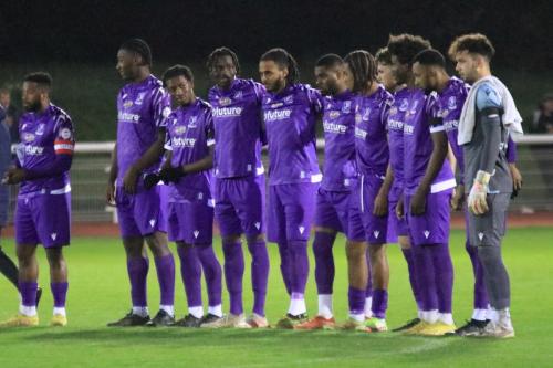 IMG 0279-The-Enfield-team-line-up-for-a-minutes-applause-in-remebrance-of-the-clubs-founding-chairman-Dave-Bryant