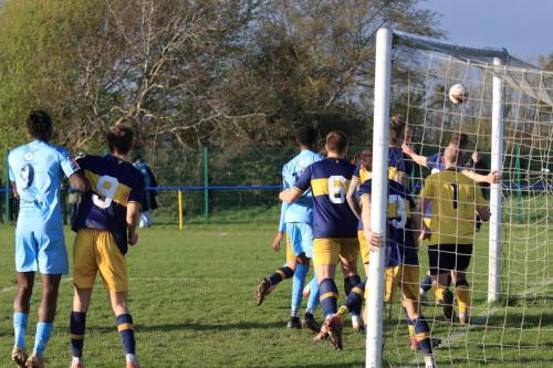 IMG 1682-The-strong-wind-meant-that-in-swinging-corners-caused-big-problems.-This-one-is-headed-clear-by-a-defender