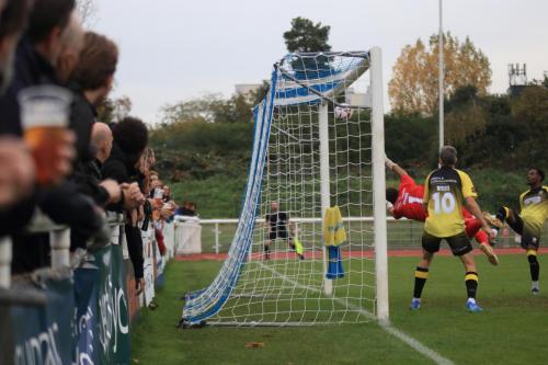 IMG 4981-Adam-Thompsons-header-hits-the-Chesham-bar-before-being-bundled-in-by-Jake-Hutchinson