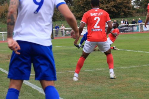 IMG 0134-Enfields-Lamar-Reynolds-is-challenged-by-Manny-Onariase-and-the-ball-flies-over-the-bar-for-a-corner.-My-view-is-blocked-by-Tommy-Wood-and-Ryan-Bartley