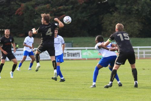 IMG 1283-Jacob-Jagger-Cane-4-appears-to-have-missed-his-header-as-Lamar-Reynolds-and-Enlyn-Lewis-5-jostle-for-position