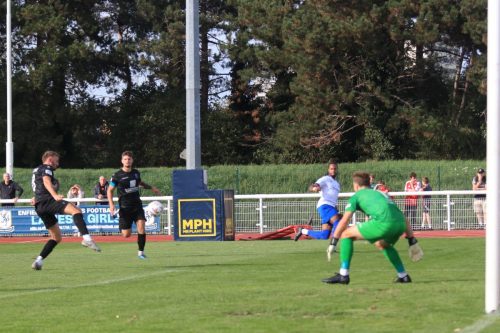 IMG 1560-Jake-Evans-L-fires-Lamar-Reynolds-cross-over-his-own-crossbar-a-bit-lower-than-he-intended