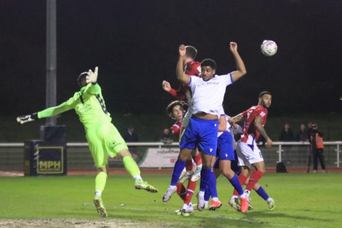 IMG 4815-Corie-Andrews-challenges-at-a-set-piece.-Im-not-sure-what-Dorking-keeper-Harrison-Foulkes-is-doing