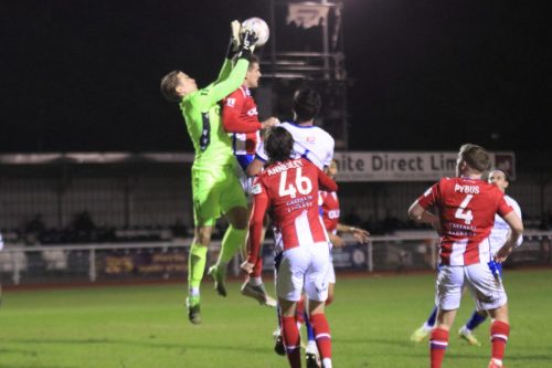 IMG 4820-Dorking-keeper-Harrison-Foulkes-fumbles-a-cross-under-pressure-from-a-team-mate