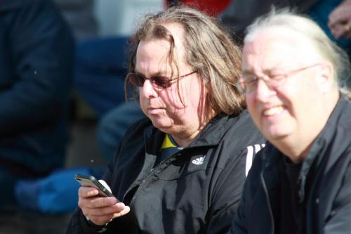 A-nervous-supporter-checks-the-scores-from-elsewhere