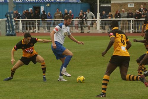 Adam Cunnington shields the ball from Cheshunt's Tom Gardiner