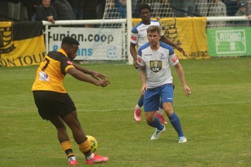 Cheshunt's Reece Beckles-Richards takes on Lee Chappell and Andre Coker (behind)