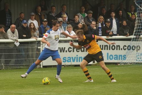 Enfield's Sam Youngs takes on Cheshunt's Adam Crowther.