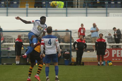 Jerry Gyebi beats Ken Charles to the header