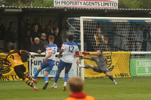 Nathan McDonald pushes a shot from Cheshunt's Ken Charles onto the post